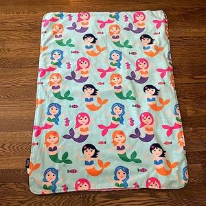Mermaid baby blanket with pink minky fabric on reverse side.